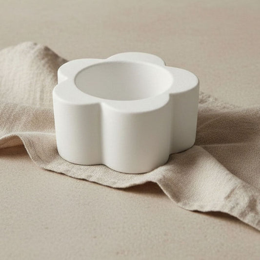 Daisy Candle holder in natural finish on beige fabric