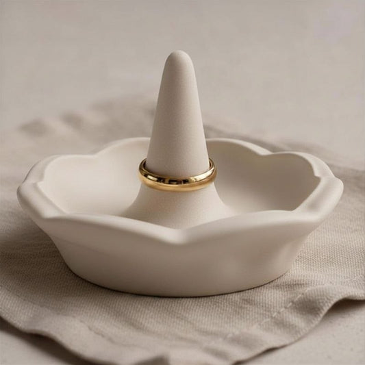 Ring holder in a beige finish on a fabric background