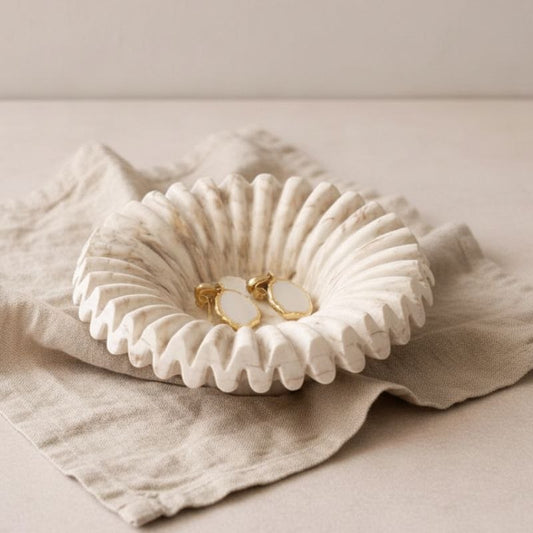 Ripple tray with marble finish and jewellery on a beige fabric