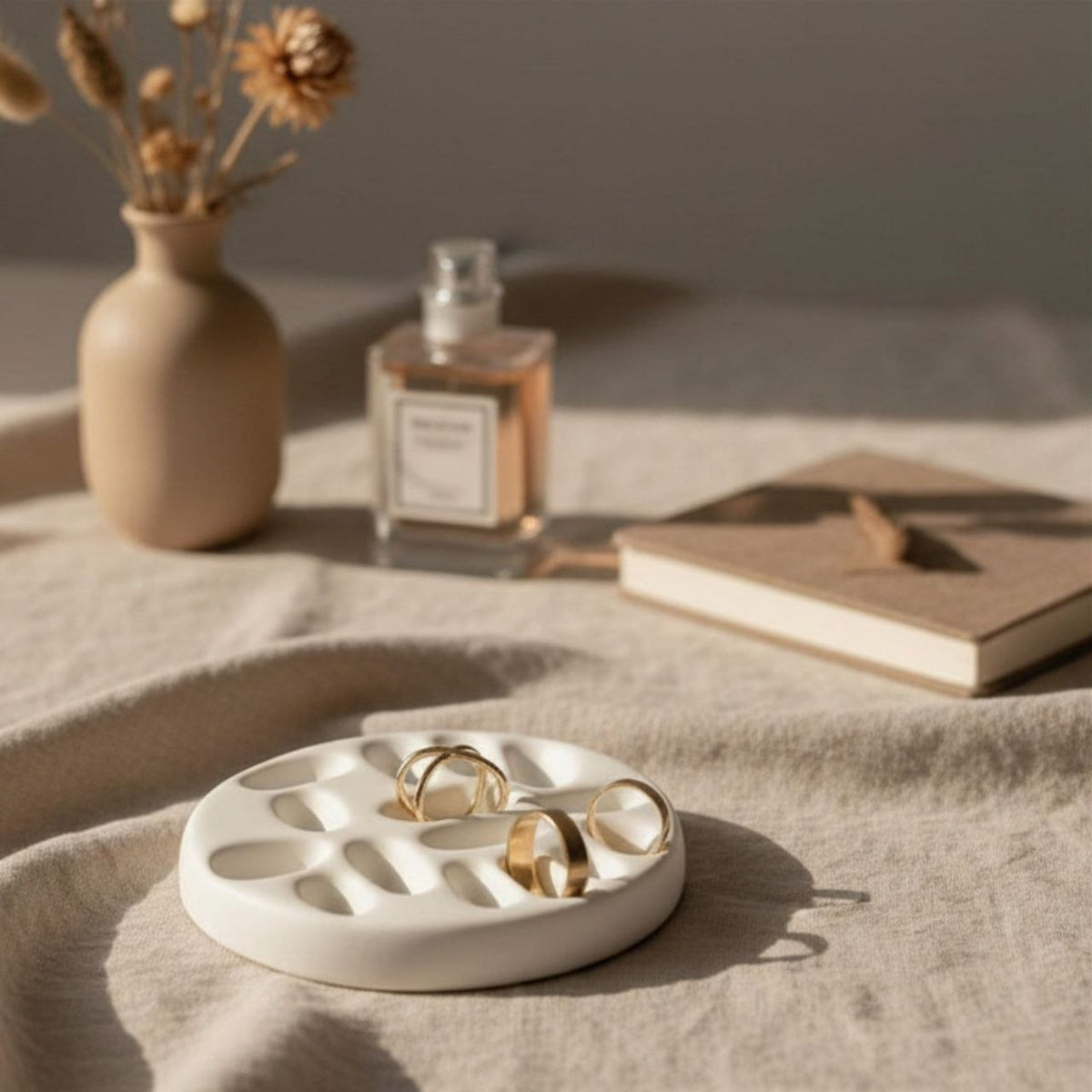 Natural colour jewelry tray with gold rings and background decor
