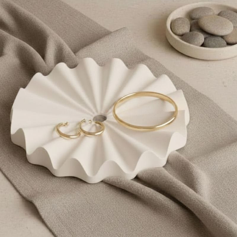 Decorative natural fluted ribbed tray with jewellery on a beige background