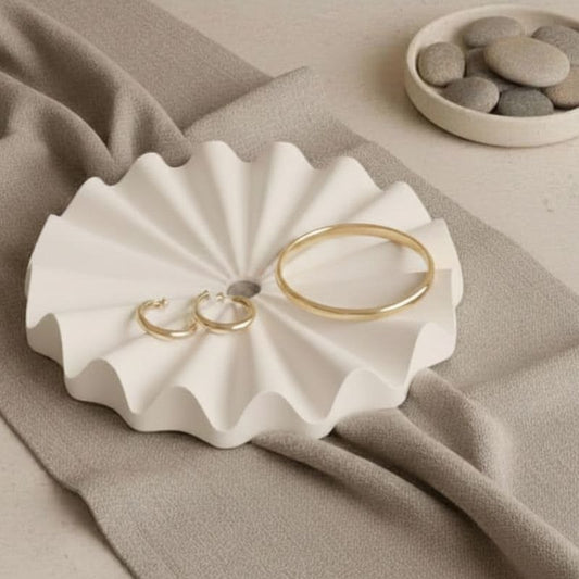 Decorative natural fluted ribbed tray with jewellery on a beige background