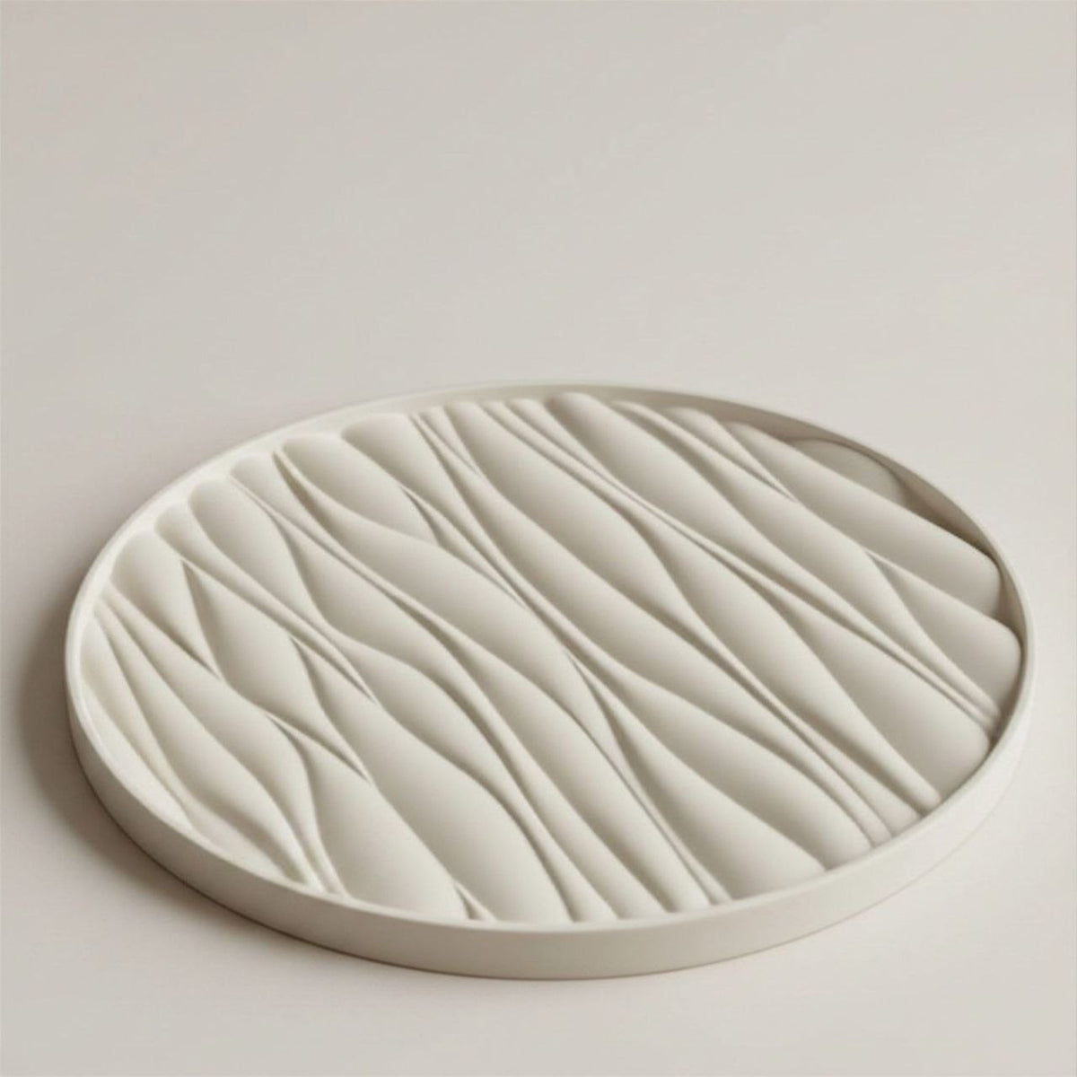 Round ceramic tray with wavy texture on a light background