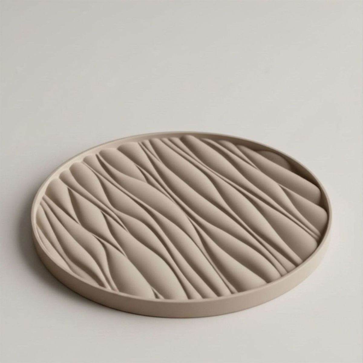 Round beige tray with wavy texture on a light gray background