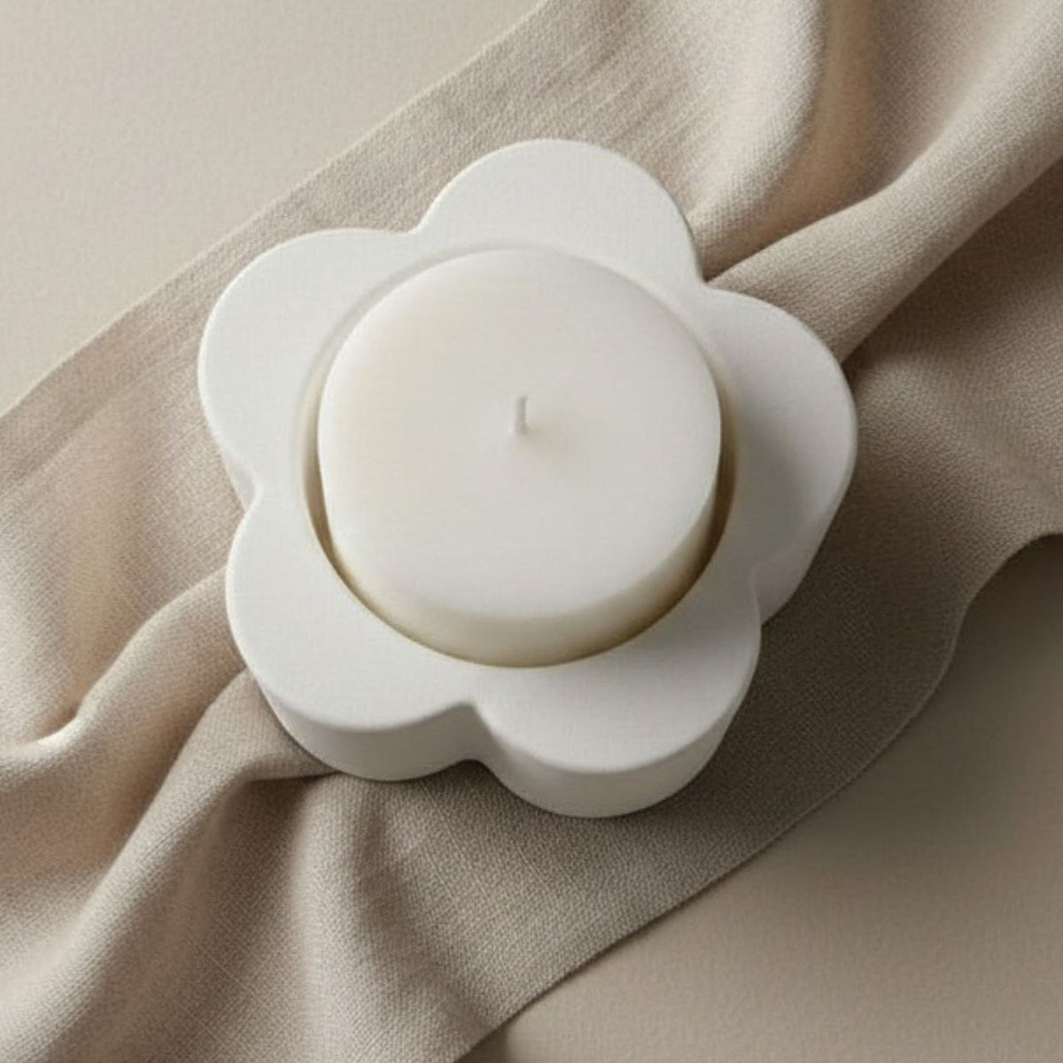 A white candle in a daisy candle  holder