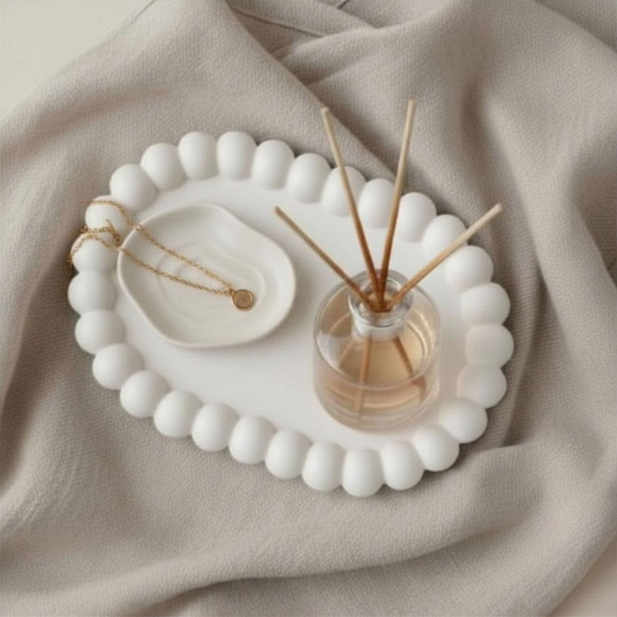 Oval bubble tray in a natural finish with a diffuser and a ceramic dish