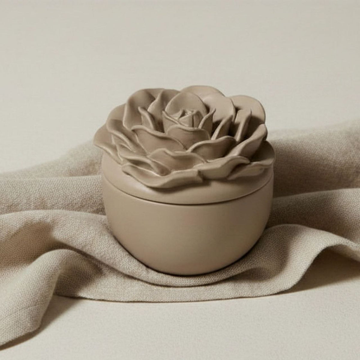 Rose jar and lid in a taupe finish on fabric