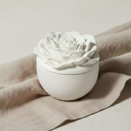 Rose jar and lid in a natural finish on beige fabric