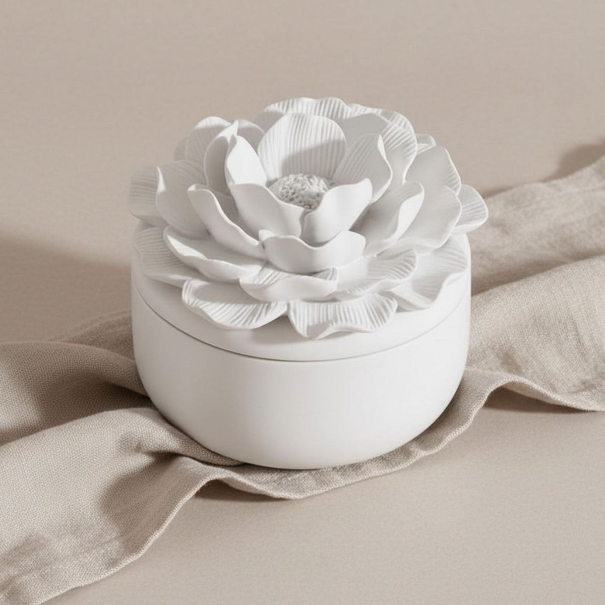 Camelia jar and lid with a natural finish on a beige background
