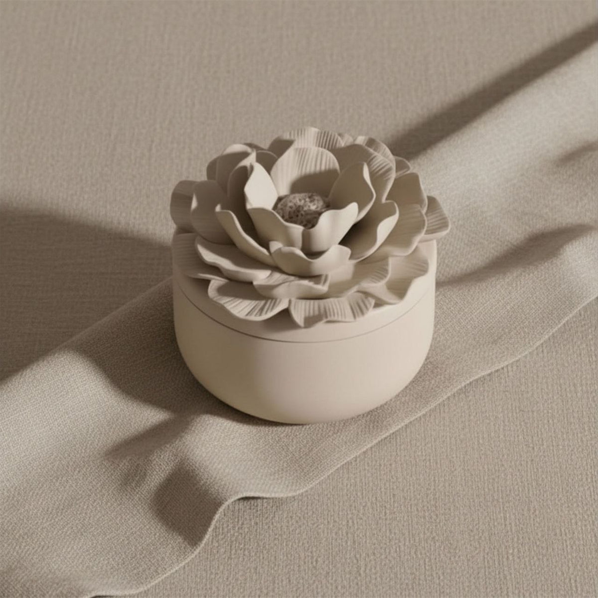 Camelia jar and lid with a taupe finish on a beige background