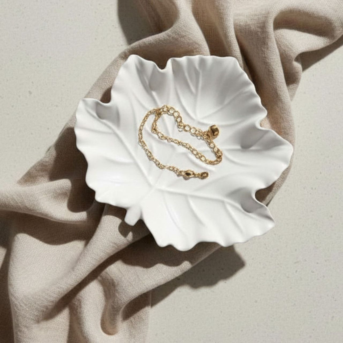 Maple leaf tray in natural finish with a gold chain