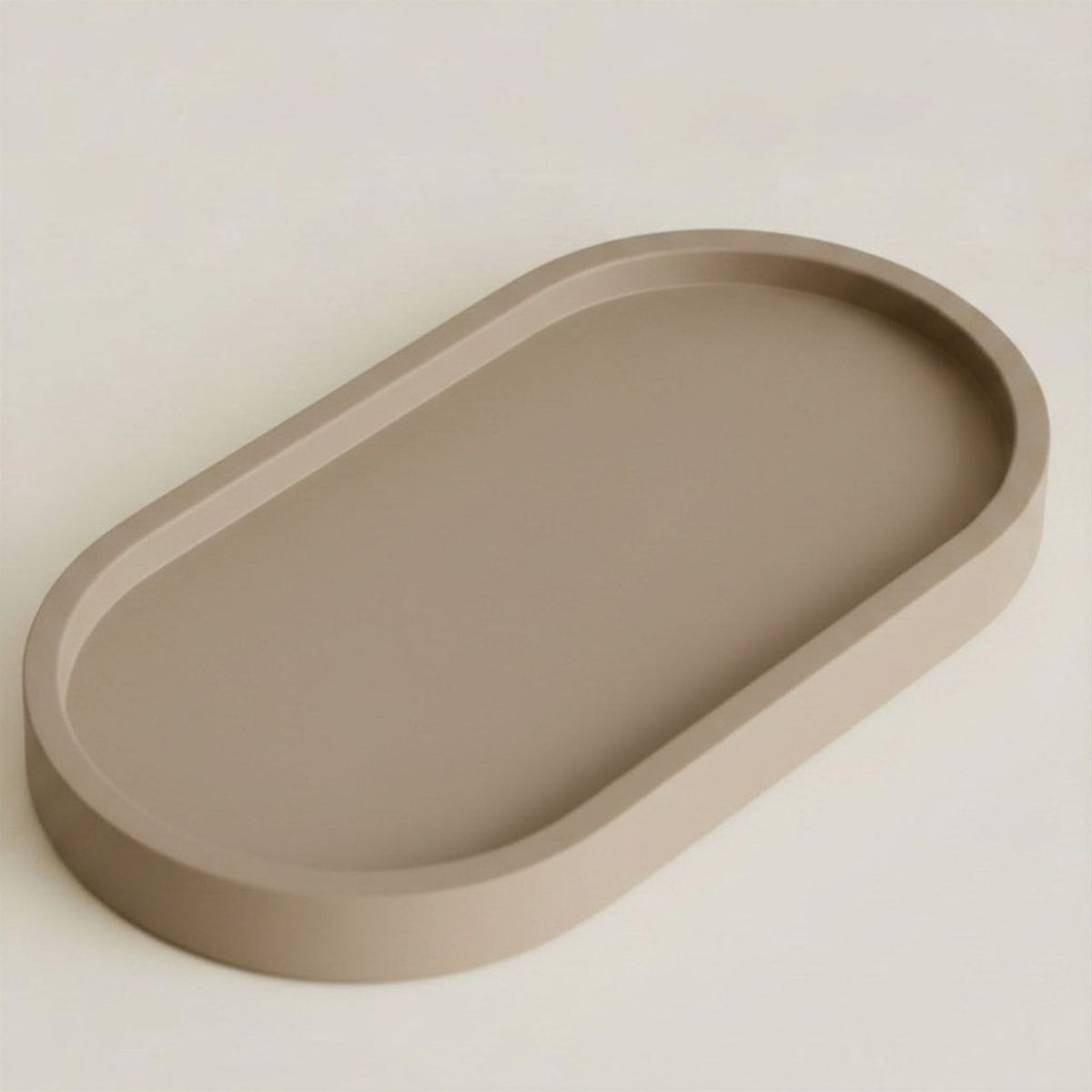Taupe oval tray on a light beige background