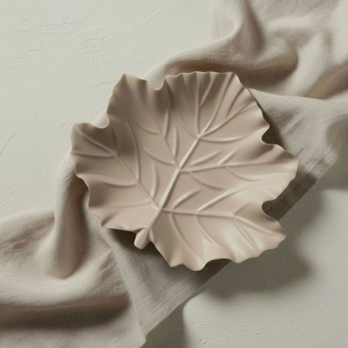Maple leaf dish on a beige fabric background