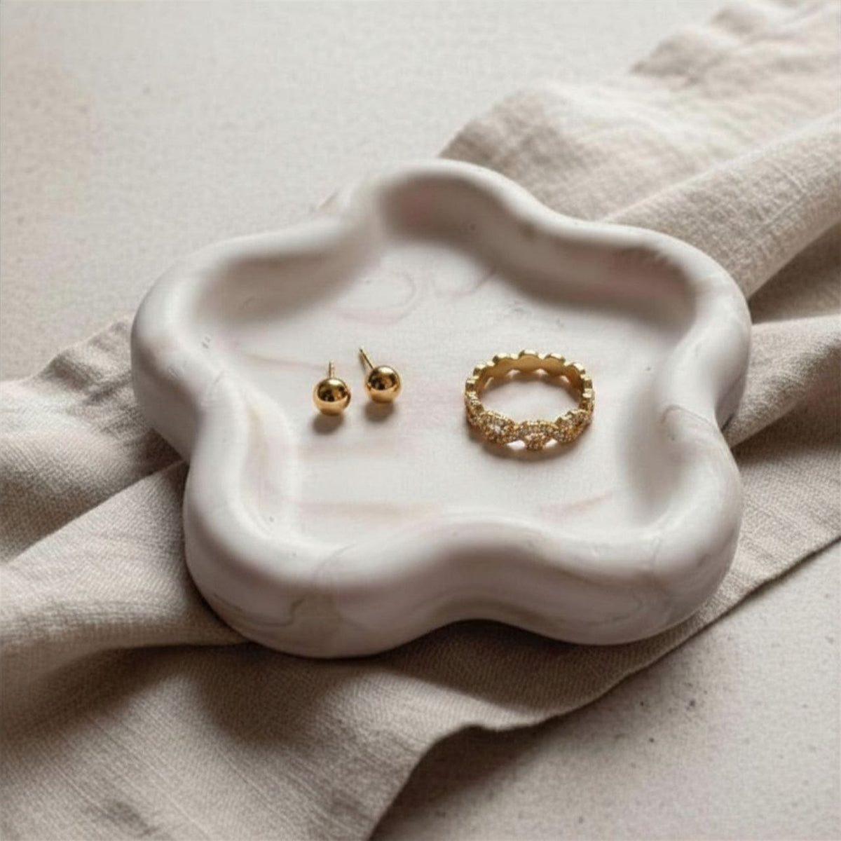 Gold Jewellery on a marble effect flower tray