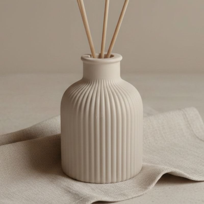 Mink finish reed diffuser on a fabric background