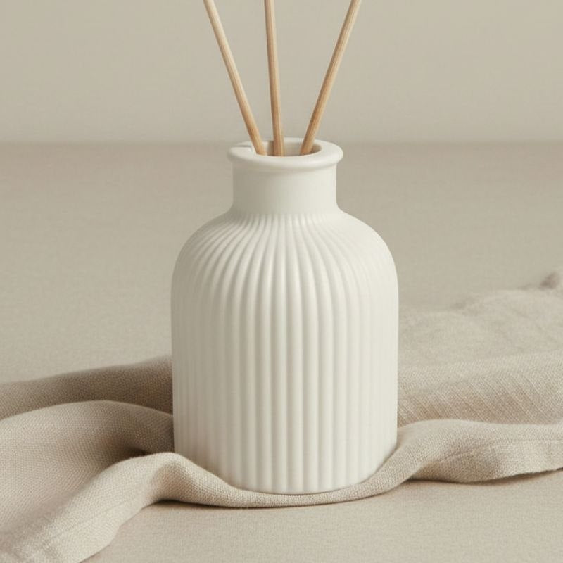 Stone finish reed diffuser on a fabric background