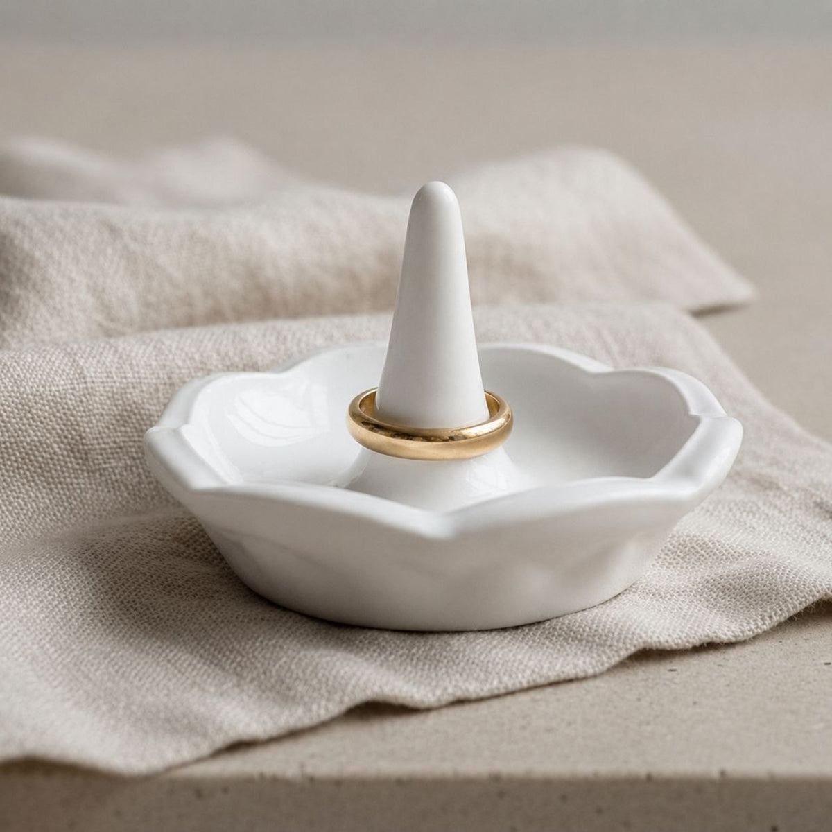 Ring holder in a natural finish on a fabric cloth