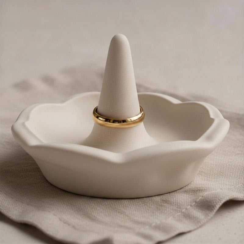 Ring holder in a beige finish on a fabric background