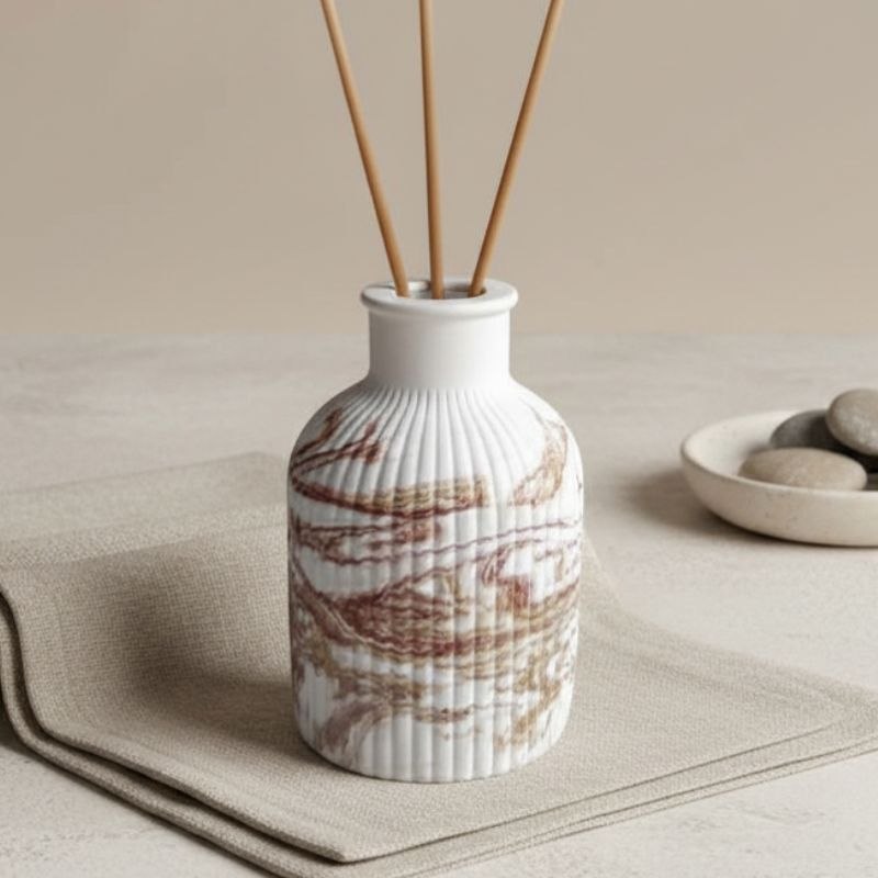 Reed diffuser with a marble finish on a fabric background